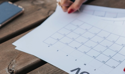 a person writing notes in a calendar