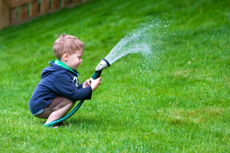 Child using garden hose