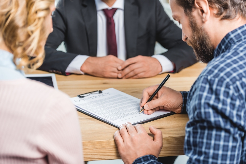 Couple signing purchase agreement