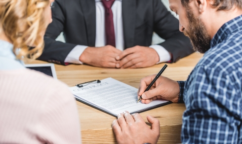 Couple signing purchase agreement